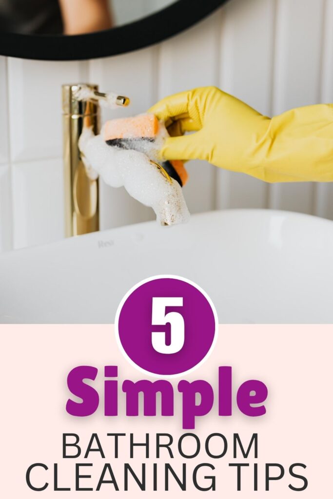 Person cleaning a brass coloured tap with a sponge whilst wearing a yellow glove. The words: 5 simple bathroom cleaning tips appear at the bottom of the image.
