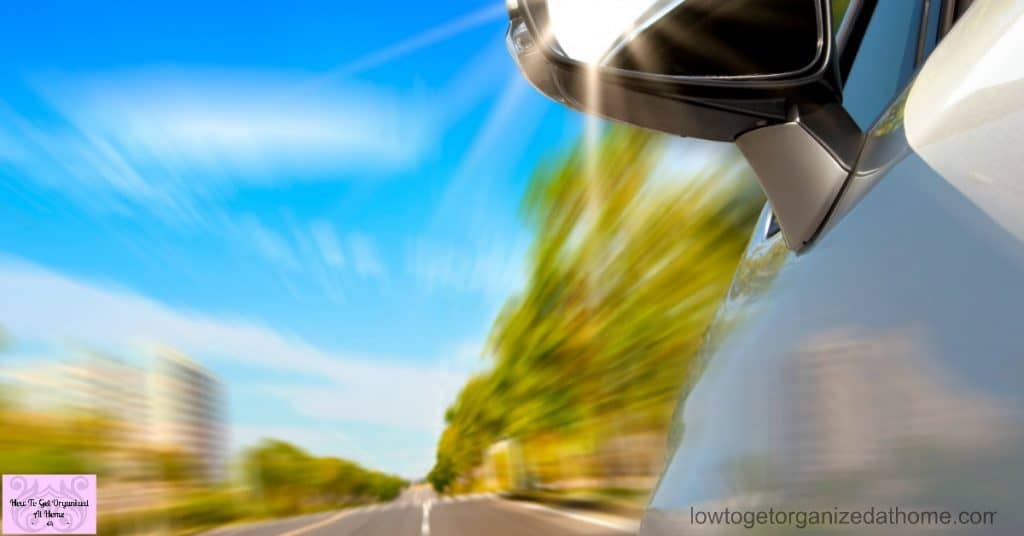 car on the road with motion blur and sunlight in the mirror