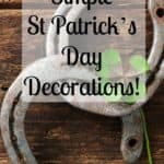 St. Patricks day, lucky charms. Two horseshoes with a four leaved clover on wooden board
