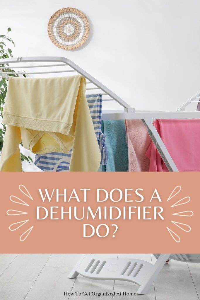 a picture of washing drying on an airer with the words what does a dehumidifier do on an orange background

