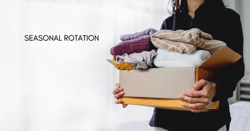 seasonal rotation. Person holding a box of jumpers.