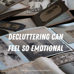 Stack of vintage photo albums with old black and white family photographs spilling out, showing the emotional weight of sentimental clutter