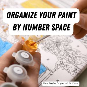 Organize your paint by number space are the words at the top of the image. The image is someone painting a paint by number painting.